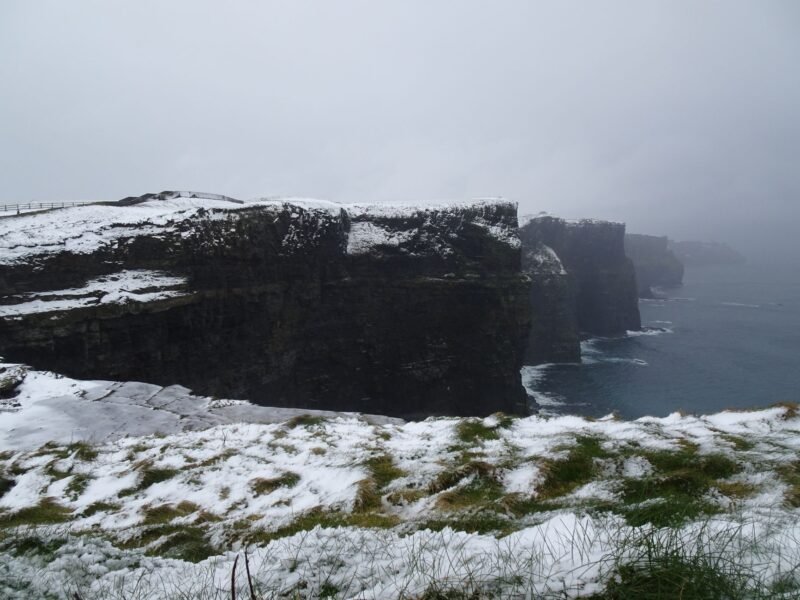 Les falaises de Moher saupoudrées de neige au-dessus de l'océan Atlantique, dans le comté de Clare