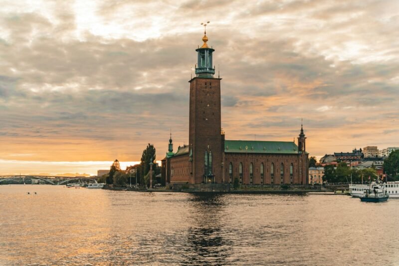 L'hôtel de ville de Stockholm au coucher du soleil, reflété dans l'eau